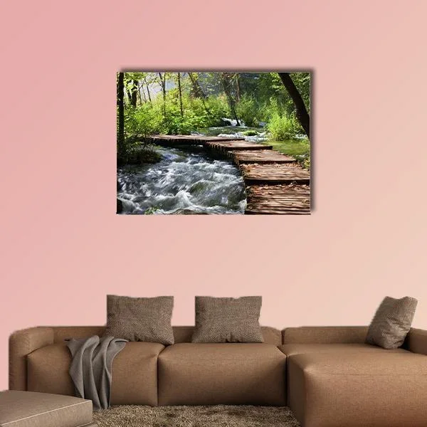 Wooden Footbridge Over Rushing Forest Stream Canvas Wall Art